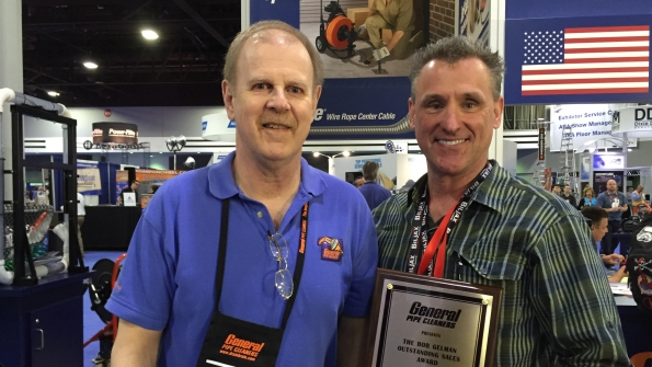 Mark Uebner right accepts the Bob Gelman Outstanding Rental Representative Award from Andy Zelazny national sales manager General Pipe Cleaners