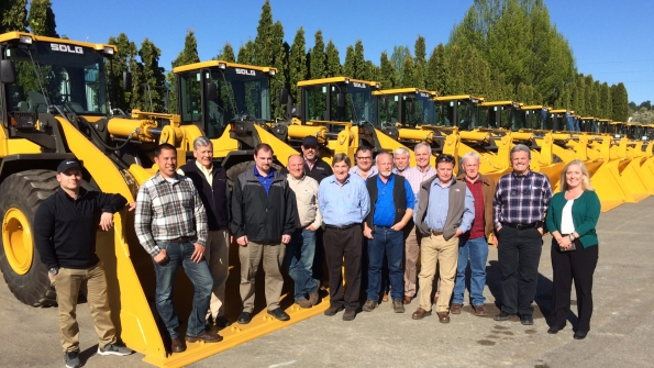 PacWest Machinery staff along with a row of wheel loaders PacWest will serve as an SDLG dealer and a distribution facility for the West Coast