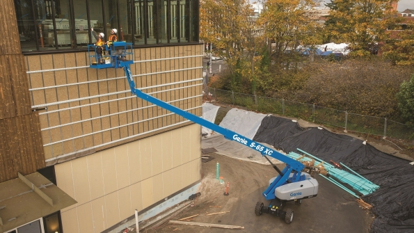 A Genie S65 XC telescopic boomlift at work