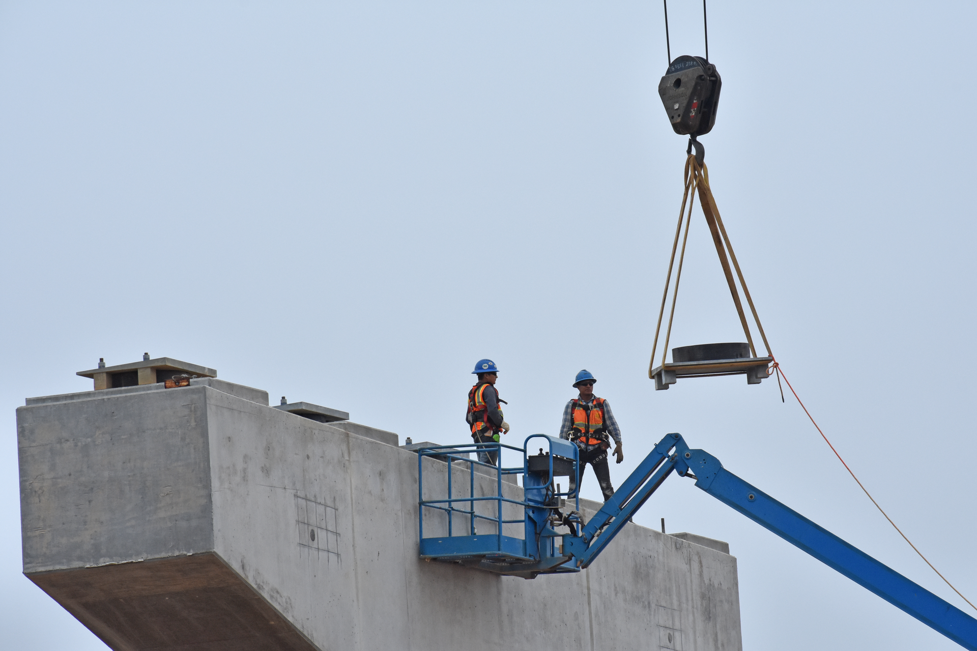 Two Bridge Construction Workers Wait On Bridge Parts Alan Stoddard 62bdb183d7a25