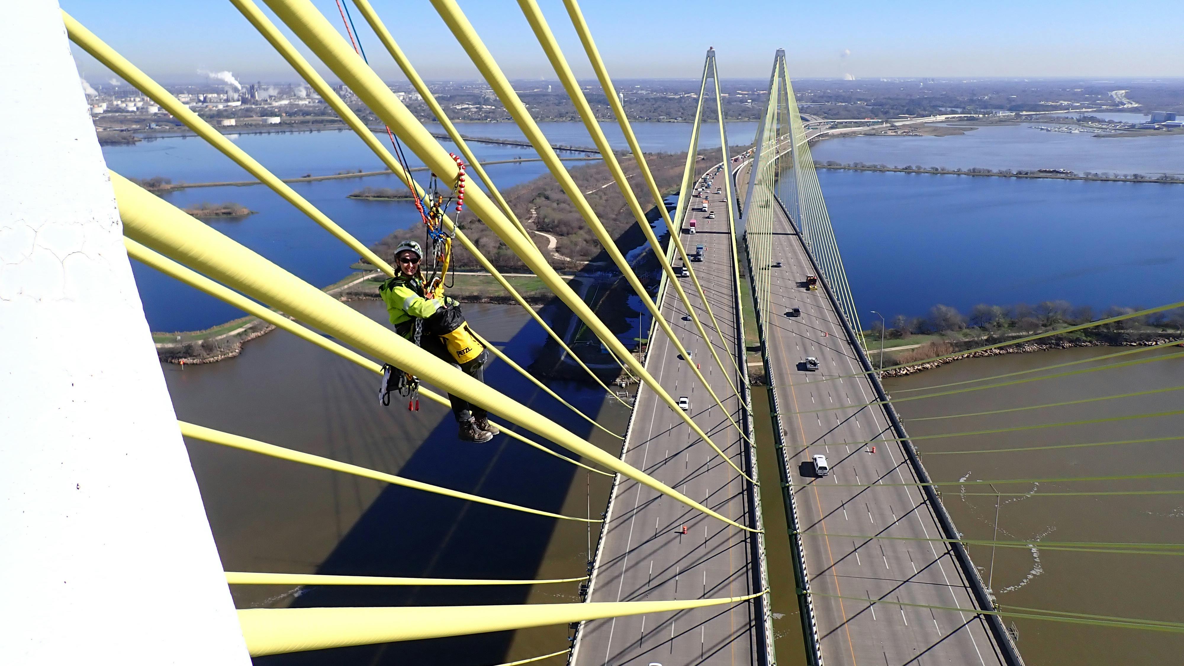 An engineer performs visual assessment of a cable on the southbound bridge using rope access.