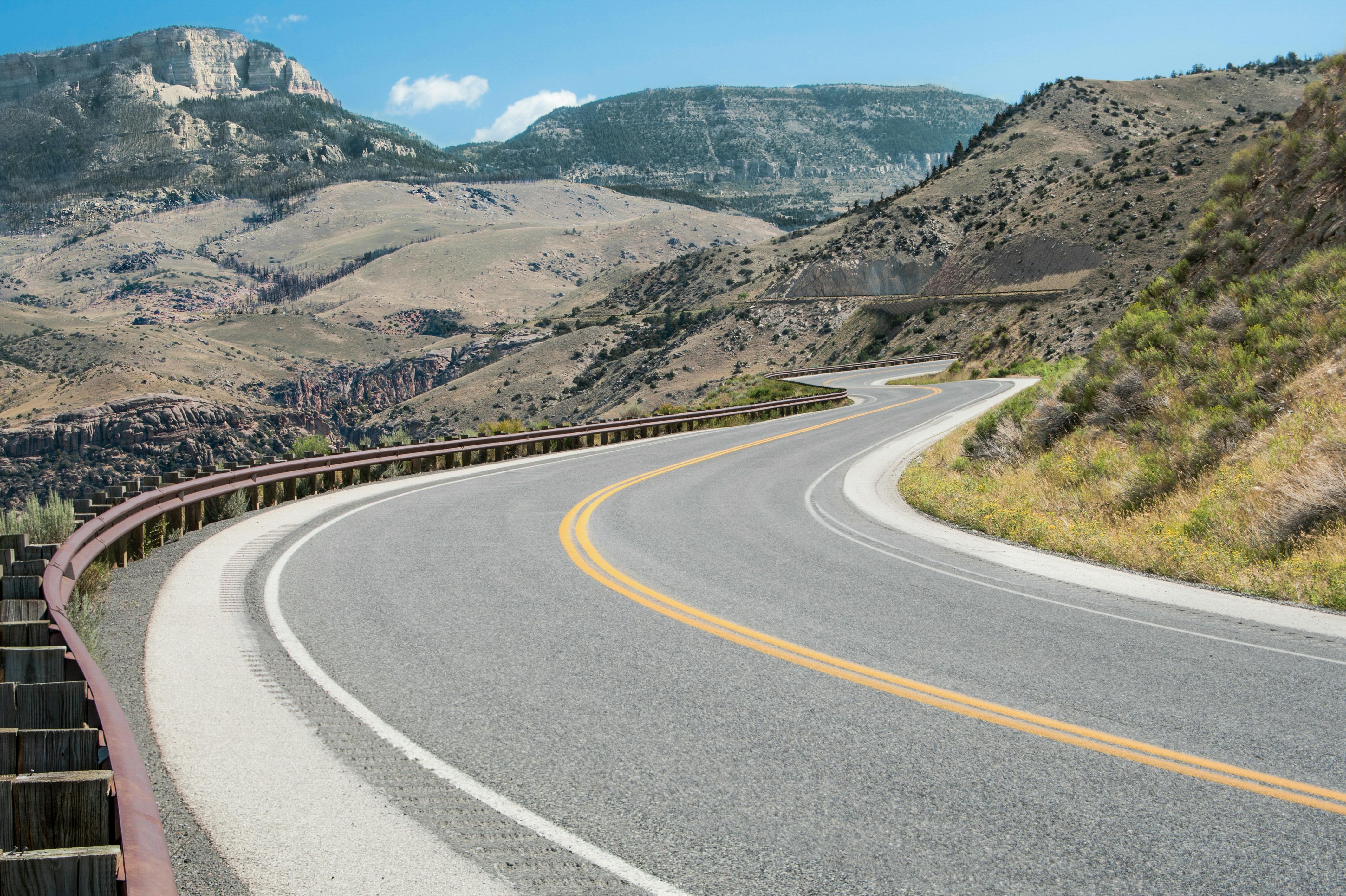 A mountain road winding through the mountains of Bighorn National Forest in northeastern Wyoming.