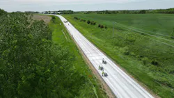 An aerial photo of crews completing a concrete overlay on a roadway in Iowa. An aerial photo of crews completing a concrete overlay on a roadway in Iowa.