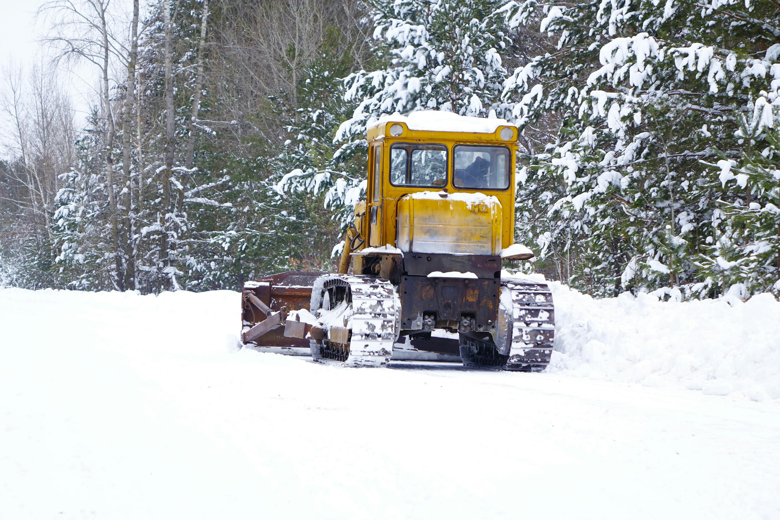 A road grader being used for snow and ice removal
