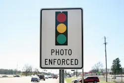 A photo enforced sign displaying a traffic light. A photo enforced sign displaying a traffic light.