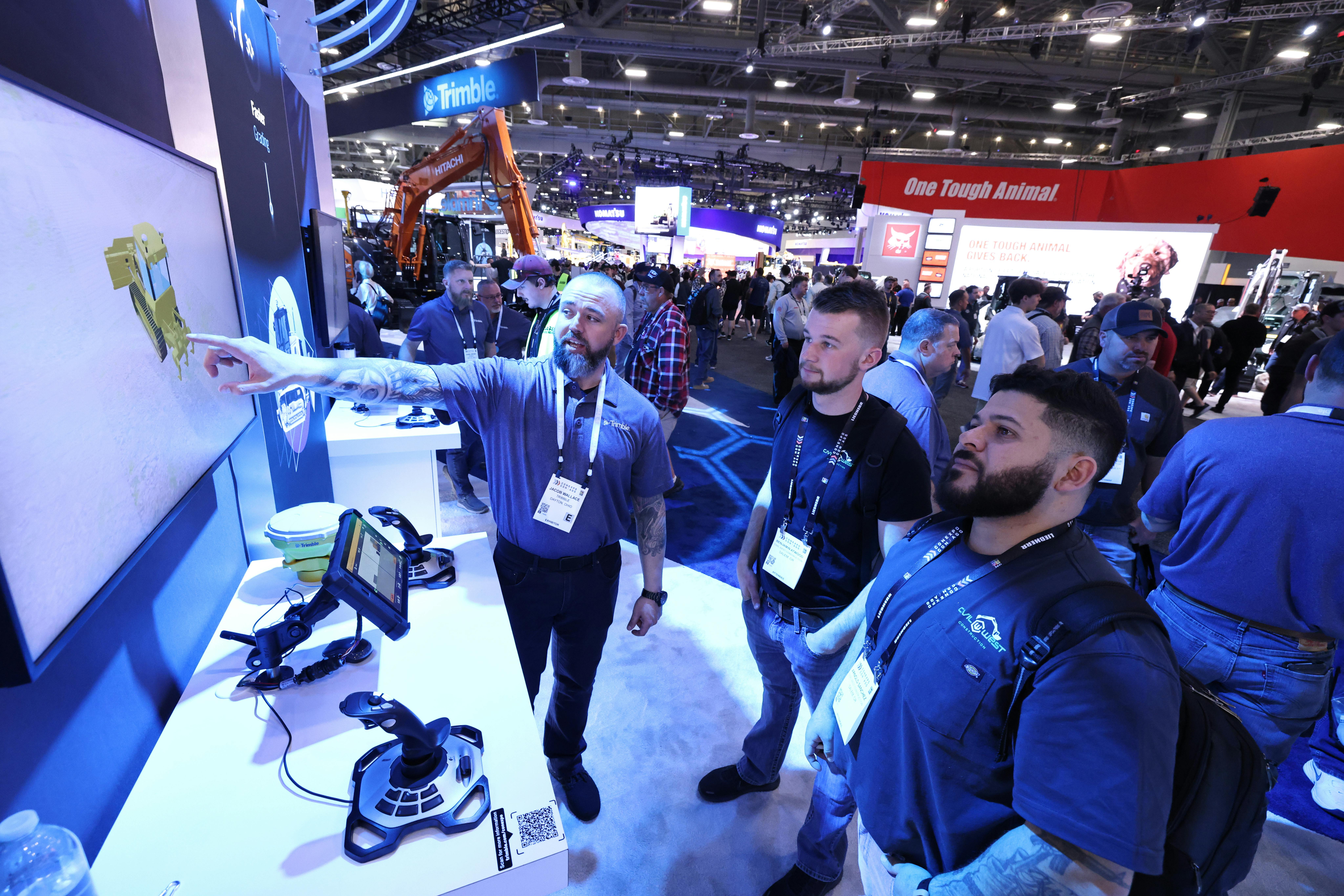 A Trimble employee showcasing new technology at CONEXPO/CON-AGG 2023.