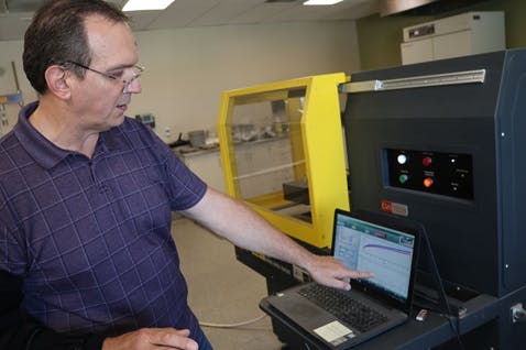 Brian Paroda pointing at a laptop displaying test results.