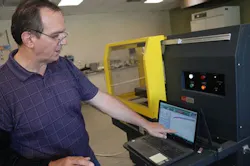 Brian Paroda pointing at a laptop displaying test results. Brian Paroda pointing at a laptop displaying test results.