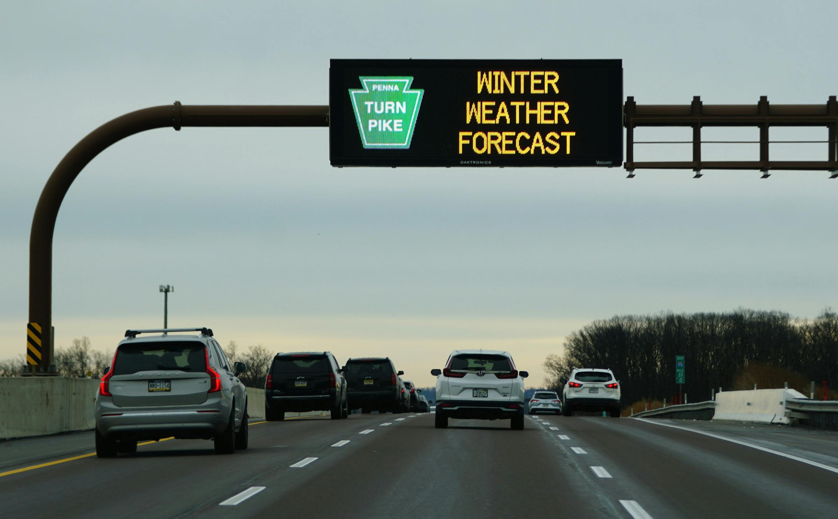 Electronic road sign on Pennsylvania Turnpike warns drivers of winter weather forecast