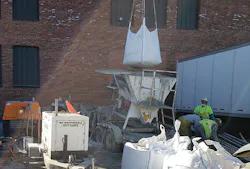The ECI crew transferring the permacast PL-8000 Super Sack to the hopper The ECI crew transferring the permacast PL-8000 Super Sack to the hopper