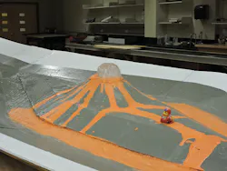 A 1:84 scale hydraulic model of the volcano erupting at a 100-year design flow. A 1:84 scale hydraulic model of the volcano erupting at a 100-year design flow.