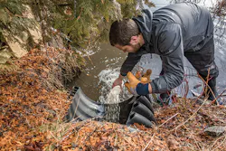 Corey Laxson collecting a stormwater runoff sample on Mirror Lake. Corey Laxson collecting a stormwater runoff sample on Mirror Lake.