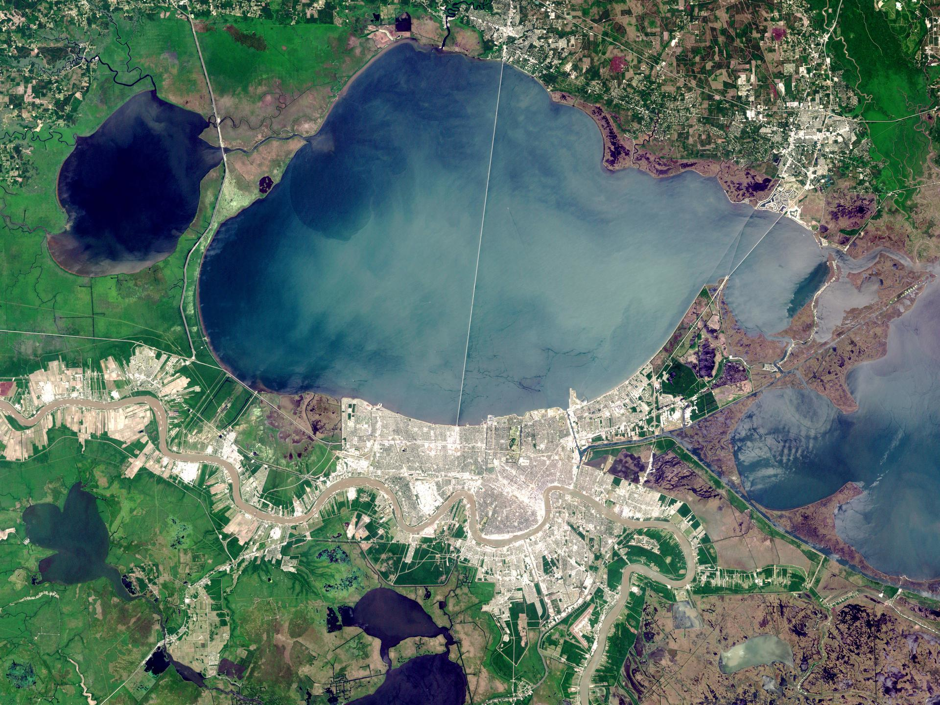 A NASA satellite image of New Orleans and Lake Pontchartrain. The smaller Lake Maurepas is on the left, with the swamp along its southern shore.