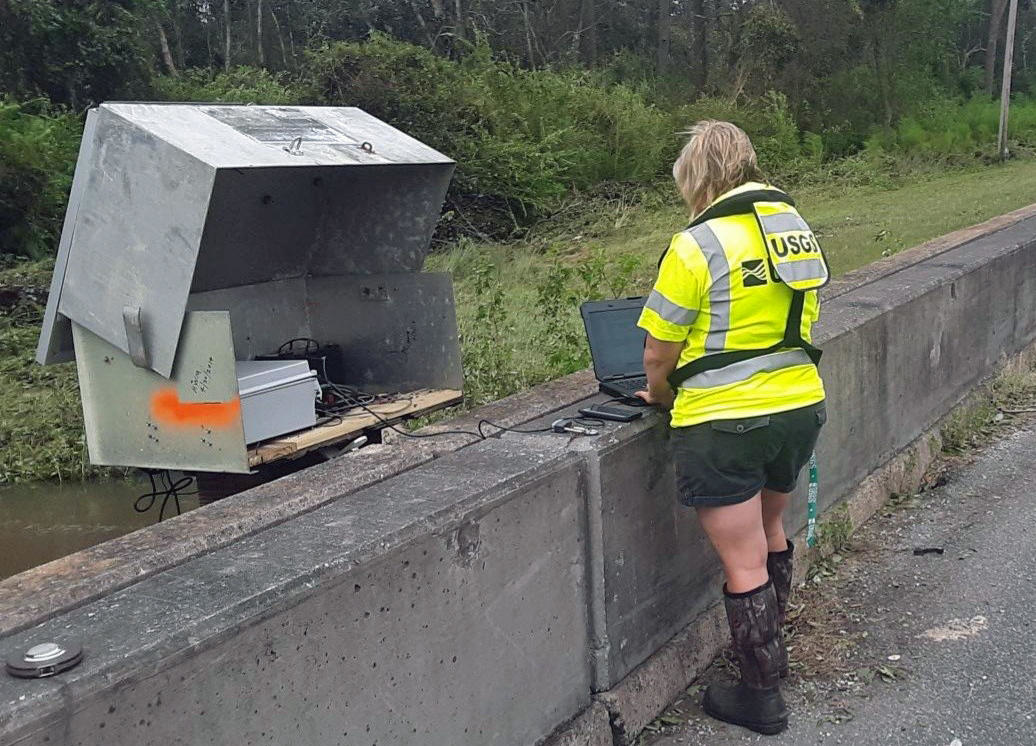 Lori Lewis, USGS hydrologic technician, verifies the readings of a USGS streamgage located on Bayou Marcus in Pensacola, FL, on September 17, 2020.