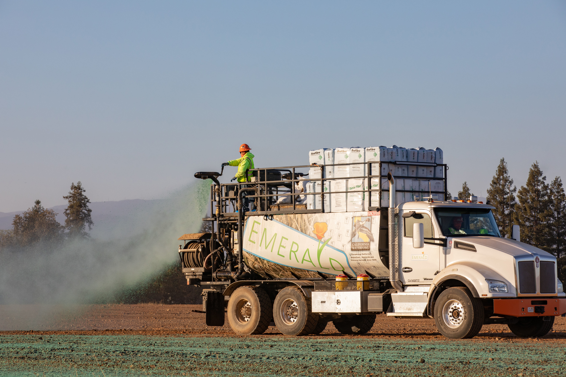Hydroseeding covers bare soil in green vegetation and acts like armor for the ground.