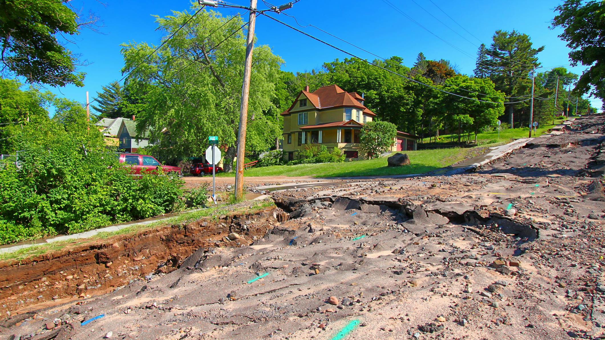 Houghton Michigan Flash Flood Damage. Houghton, Michigan, USA - June 18, 2018: Intense storm rainfall and flash flooding in June of 2018 caused property damage and completely washed out Agate Street in the town of Houghton, Michigan.