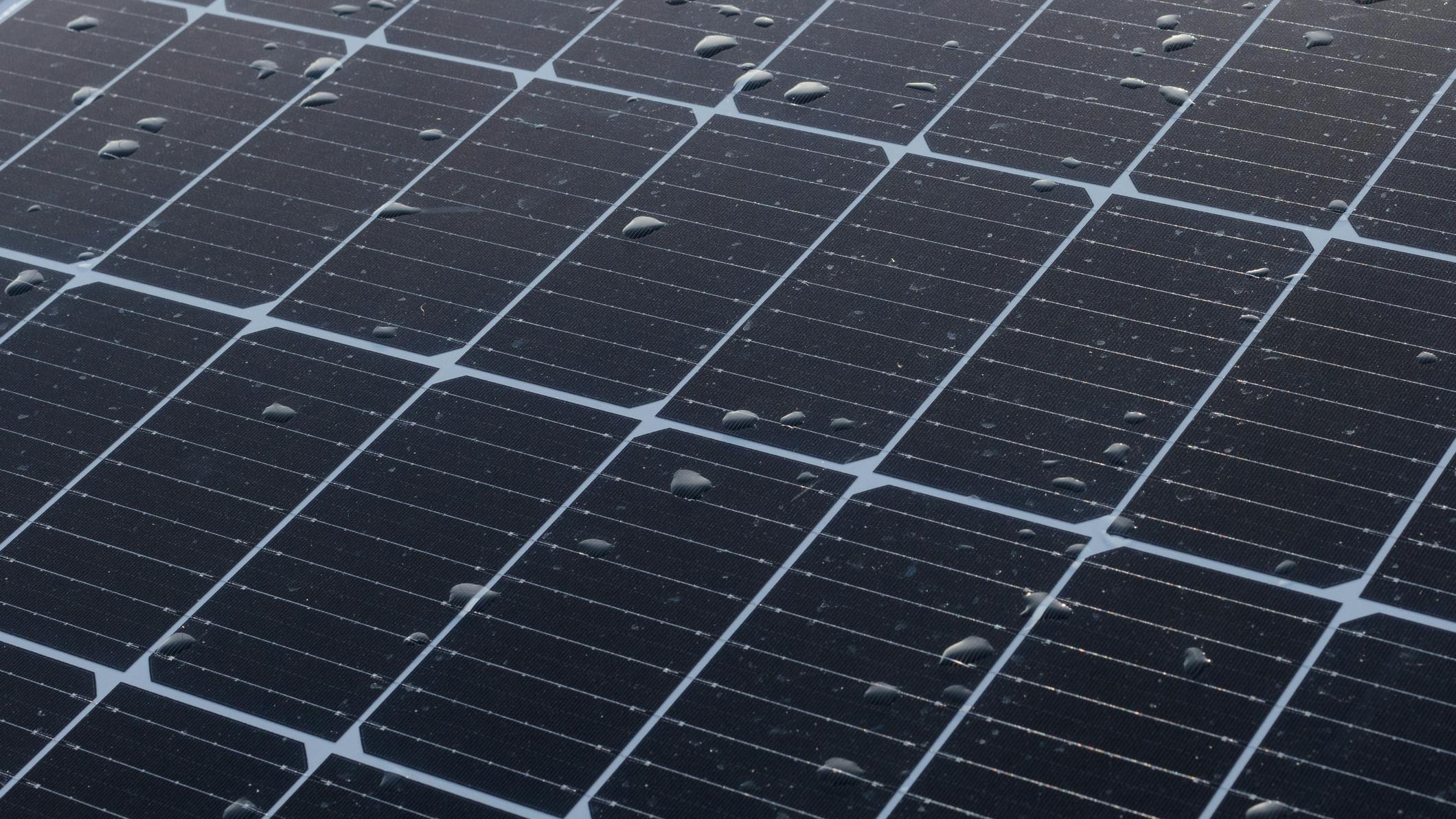 Solar panels on a construction site with raindrops on them