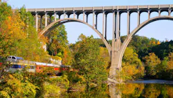 Arched bridge and passenger train Arched bridge and passenger train
