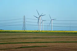 Meadow with Wind mill turbines generating electricity and electric power lines, in England, the UK Meadow with Wind mill turbines generating electricity and electric power lines, in England, the UK