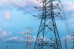 high-voltage power lines at blue sky electricity transmission pylon. Part of high-voltage substation with switches and disconnectors high-voltage power lines at blue sky electricity transmission pylon. Part of high-voltage substation with switches and disconnectors