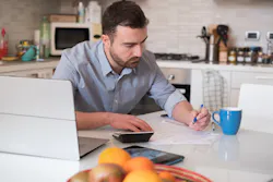 Man calculating bills and tax expenses Man calculating bills and tax expenses