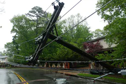 Electricity distribution pole uprooted in a storm Electricity distribution pole uprooted in a storm