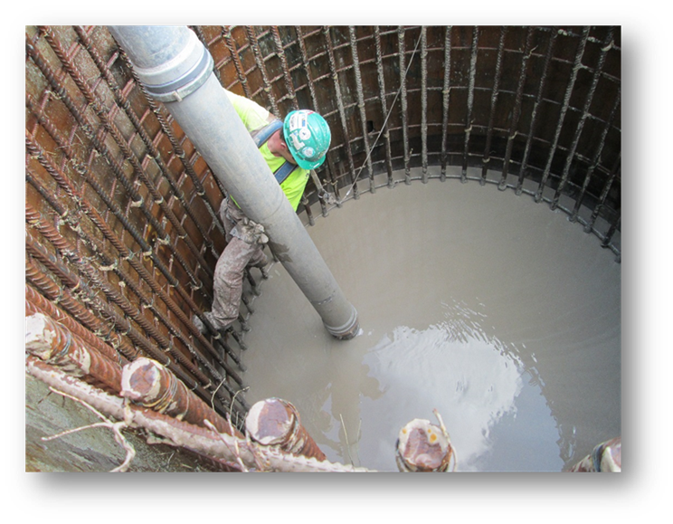 Workers working on transmission line across river valley