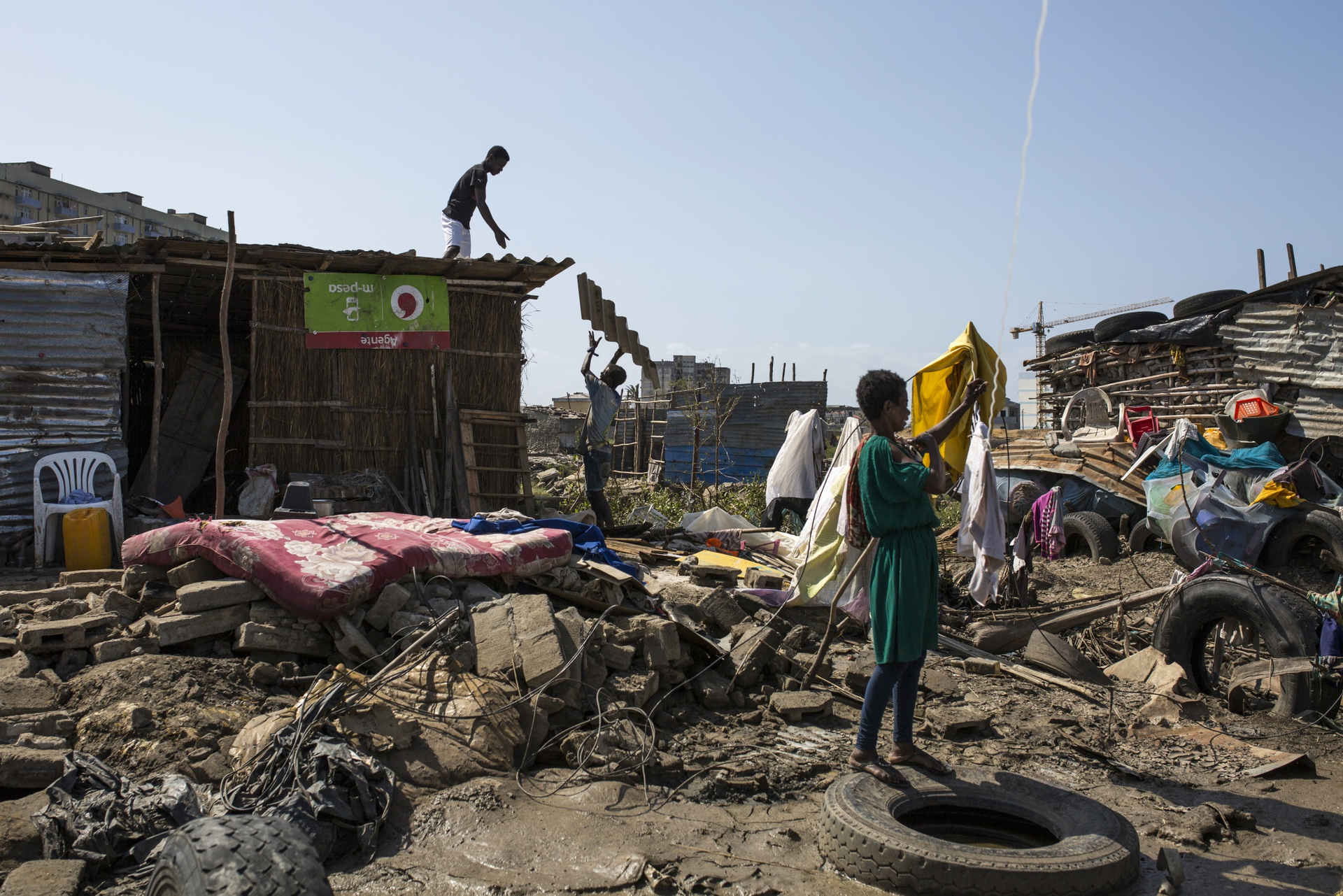 People go through their belongings in the wake of destruction by a storm