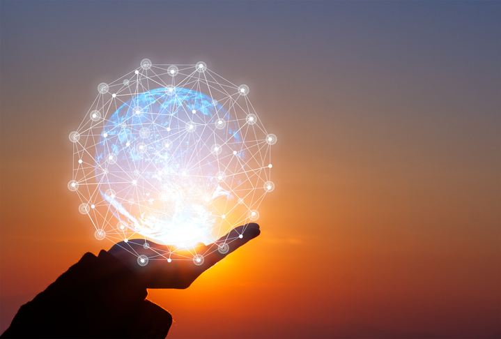 A hand supporting a hologram of the earth with interconnected network lines