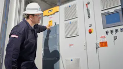 A man operating a battery storage unit A man operating a battery storage unit
