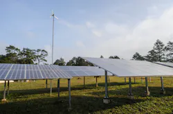 A wind turbine and a range of solar panels A wind turbine and a range of solar panels