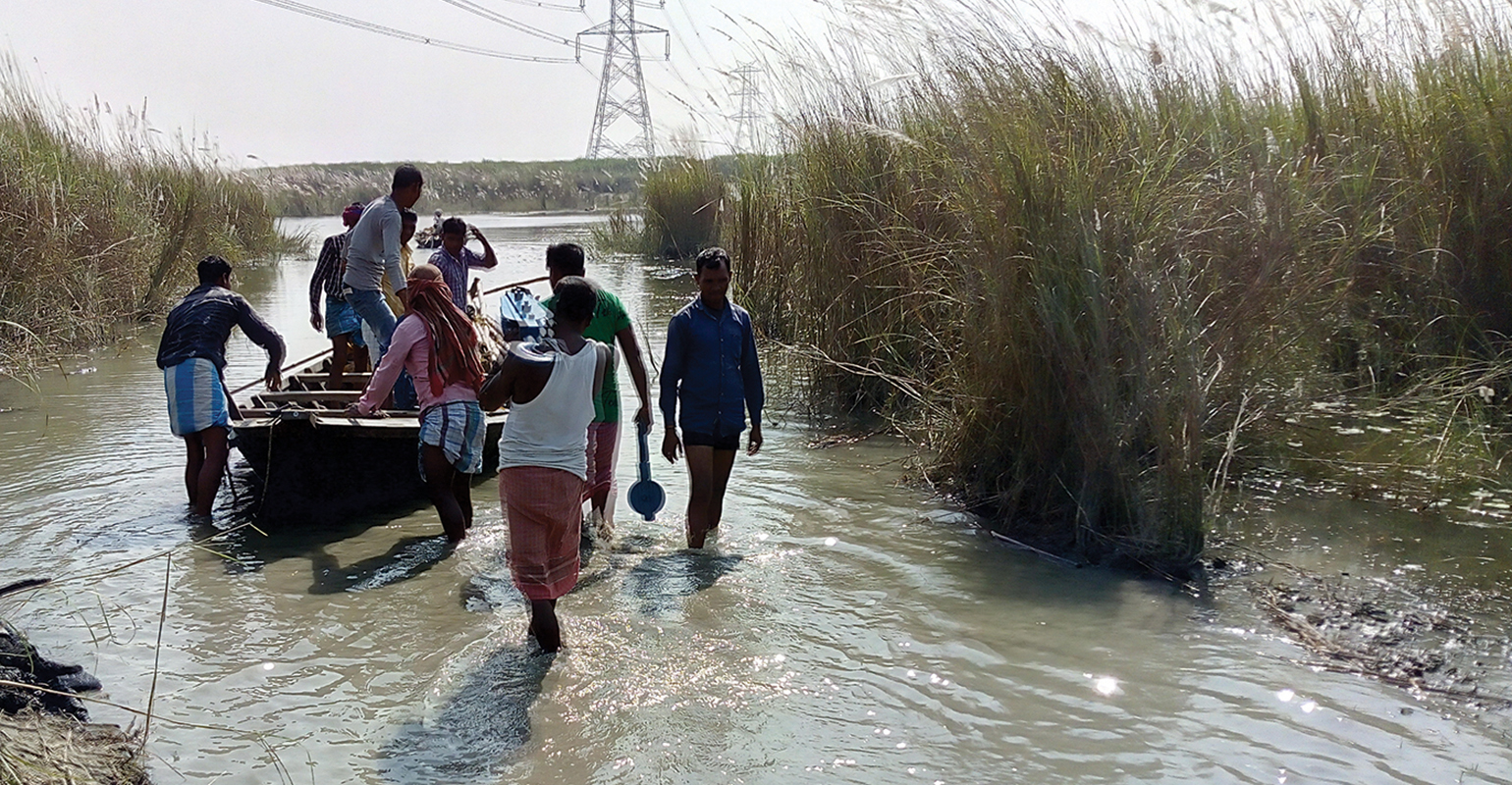 Overhead construction workers travel to tower position by boat for river crossing structure work