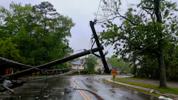 Damaged power lines hanging over a road after a storm Damaged power lines hanging over a road after a storm
