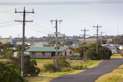 Electric poles and overhead lines alongside a road Electric poles and overhead lines alongside a road