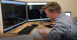 A man working on data in front of computers A man working on data in front of computers