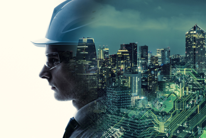 A composite image of an engineer's face and an illuminated city scape