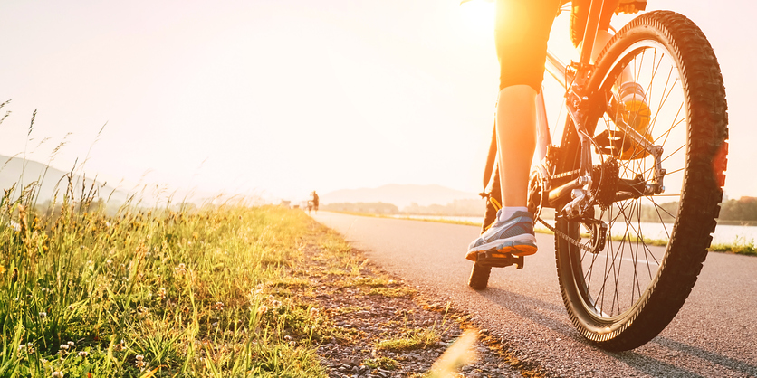 A cyclist pedaling down the road
