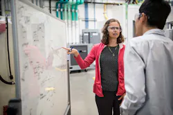 NREL researchers discussing data on a whiteboard NREL researchers discussing data on a whiteboard