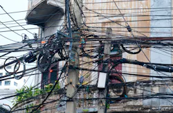 Entangled electric wires on an electric pole Entangled electric wires on an electric pole