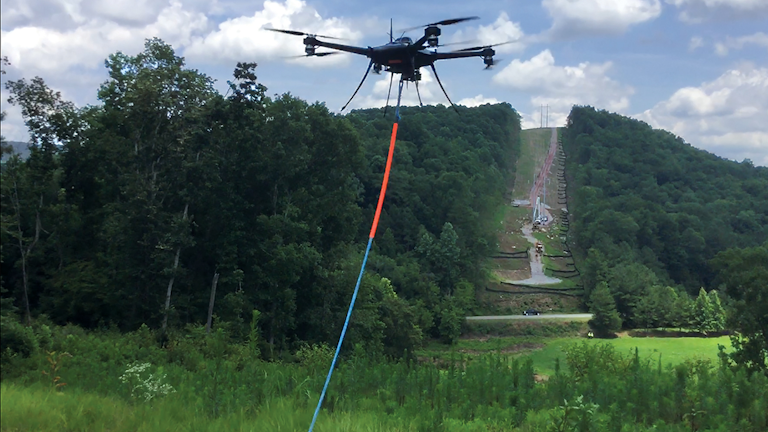 Alabama Power and Service Electric Co. partner to pull ropes across large valleys near Springville, Alabama.