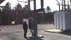 Brandon Lankford, WCEC power quality technician, performs an inspection on a circuit switcher.