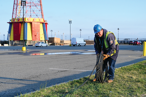 Con Edison's emergency operations supervisor Al Marchione rolling out the cable that will be installed to feed the temporary shed to power Coney Island Hospital MCU Park Brooklyn.