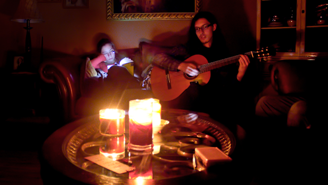 Couple in candlelit home due to Hurricane Sandy massive power outage in New York on Oct 31, 2012. Sandy struck New York October 29 leaving 1 million Long Islanders without power.