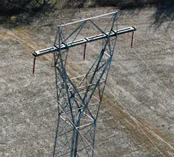 Aerial photo of the lattice tower with crossarm in bending. Aerial photo of the lattice tower with crossarm in bending.