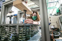 Postdoctoral researcher Allison Mahvi is investigating thermal storage at the NREL's Thermal Test Facility. She is compressing the thermal storage device to improve the thermal contact between the heat exchanger and the phase change composite. This allows for charging and discharging the device more quickly. Postdoctoral researcher Allison Mahvi is investigating thermal storage at the NREL's Thermal Test Facility. She is compressing the thermal storage device to improve the thermal contact between the heat exchanger and the phase change composite. This allows for charging and discharging the device more quickly.