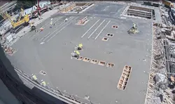 First-floor concrete finishing underway. In the foreground are the framed openings for the control room. Mid-ground, notice embedded rails for GIS (on left) and 13.2-kV switchgear (on right) with transformer bays, with drive bay (in middle at top). First-floor concrete finishing underway. In the foreground are the framed openings for the control room. Mid-ground, notice embedded rails for GIS (on left) and 13.2-kV switchgear (on right) with transformer bays, with drive bay (in middle at top).