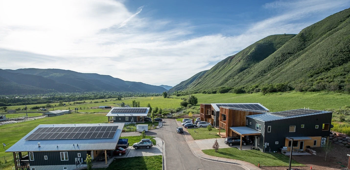 Cộng đồng Nhà ở Giá cả phải chăng Basalt Vista, ở thị trấn nông thôn Basalt, Colorado — dân số 4.170, NREL đang thử nghiệm một trong những giải pháp vận hành lưới điện mới nhất của mình. Các thành viên của hợp tác xã điện địa phương Holy Cross Energy đang chia sẻ điện năng giữa các tấm pin mặt trời, pin, máy sưởi và xe điện.