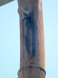 Wood pole splintered and burnt in insulation coordination gap because of suspected repeated lightning flashover and resulting power frequency follow-through current. Wood pole splintered and burnt in insulation coordination gap because of suspected repeated lightning flashover and resulting power frequency follow-through current.