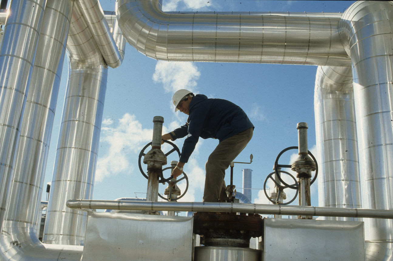 A worker adjusts valves at a California solar thermal power plant.