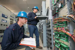 Utility substation technicians performing routine maintenance. Utility substation technicians performing routine maintenance.